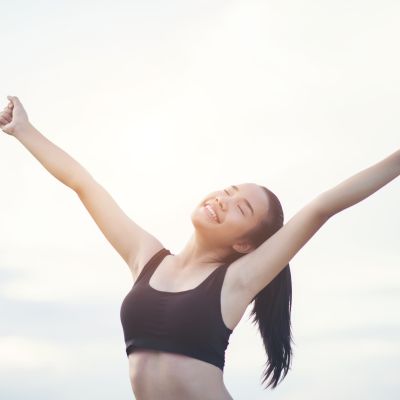 happy smiling athletic woman with arms outstretched scaled 538b502c